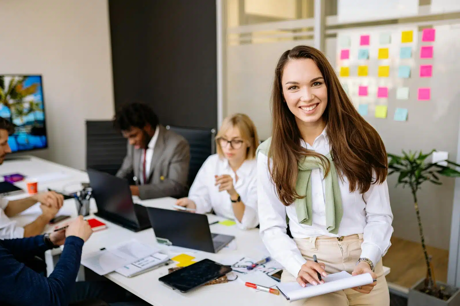 Smiling professionals working together in a modern office setting.