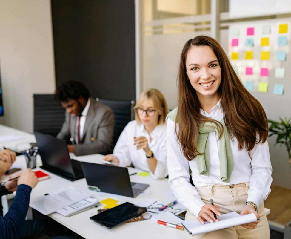 Smiling professionals working together in a modern office setting.
